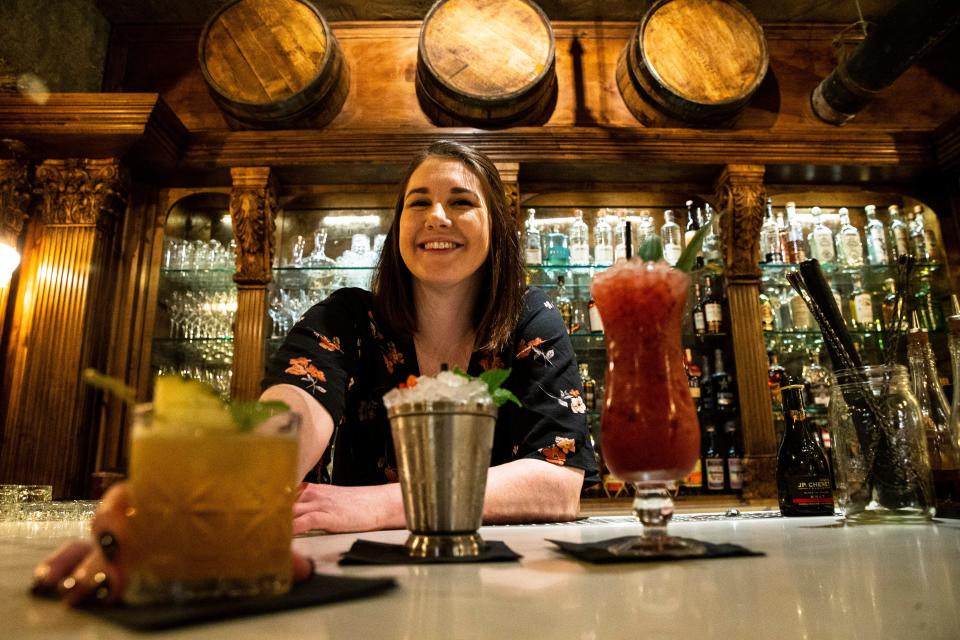 Bar manager Heather Gerry serves the Montezuma's Castle cocktail (from left) along with the President's Julep and West Coast Experience cocktails at Rough Rider restaurant and cocktail bar in Phoenix.