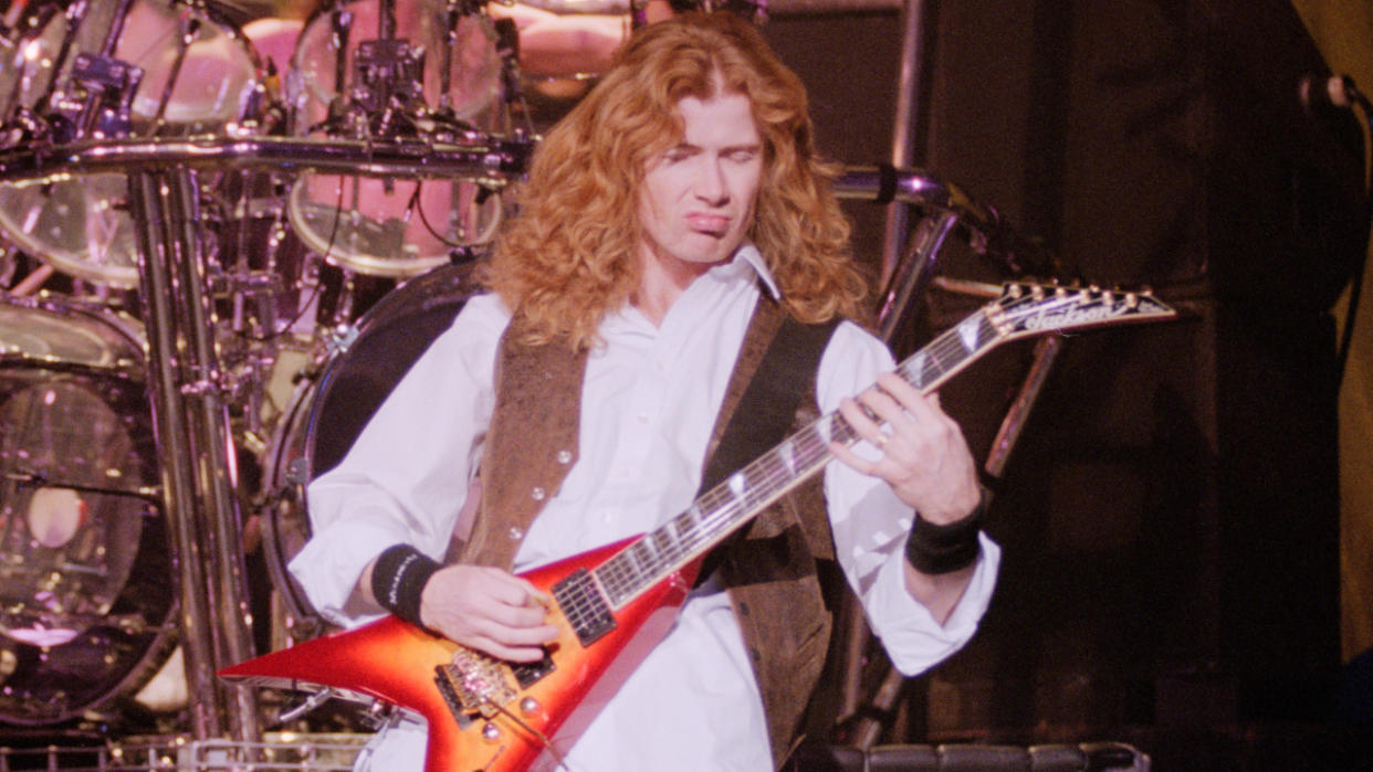  Dave Mustaine playing guitar onstage in 1995 