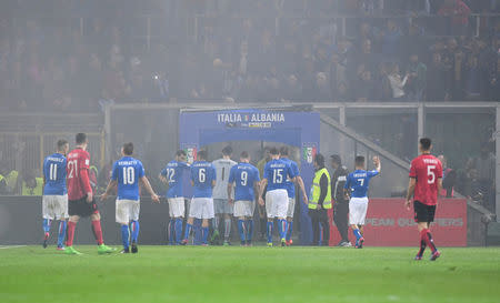 Football Soccer - Italy v Albania - World Cup 2018 Qualifiers - Group G - Renzo Barbera stadium, Palermo, Italy - 24/3/17. Italy's and Albania's players leave the pitch as the referee suspends the match after supporters lit flares during the match. REUTERS/Alberto Lingria