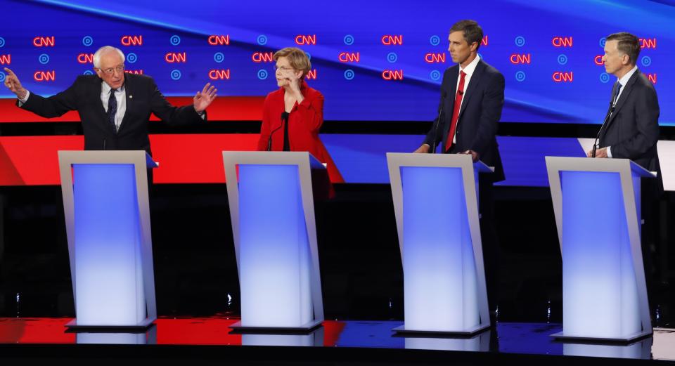 Sen. Bernie Sanders, I-Vt., Sen. Elizabeth Warren, D-Mass., former Texas Rep. Beto O'Rourke and former Colorado Gov. John Hickenlooper participate in the first of two Democratic presidential primary debates hosted by CNN Tuesday, July 30, 2019, in the Fox Theatre in Detroit. (AP Photo/Paul Sancya)