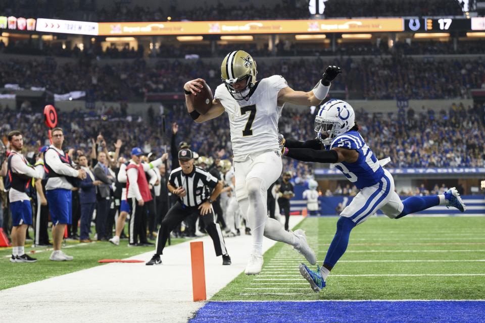 New Orleans Saints quarterback Taysom Hill (7) runs past Indianapolis Colts cornerback Kenny Moore II (23) for a touchdown during an NFL football game, Sunday, Oct. 29, 2023, in Indianapolis. | Zach Bolinger, Associated Press