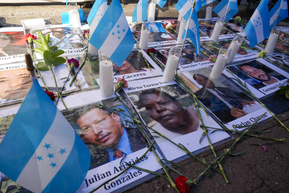 A makeshift shrine with photos of a victim of Honduran drug cartels is seen outside Federal court, Friday, March 8, 2024, in New York. Former Honduran President Juan Orlando Hernandez has been convicted in New York of conspiring with drug traffickers, his military and police to enable tons of cocaine to reach the United States. (AP Photo/Mary Altaffer)