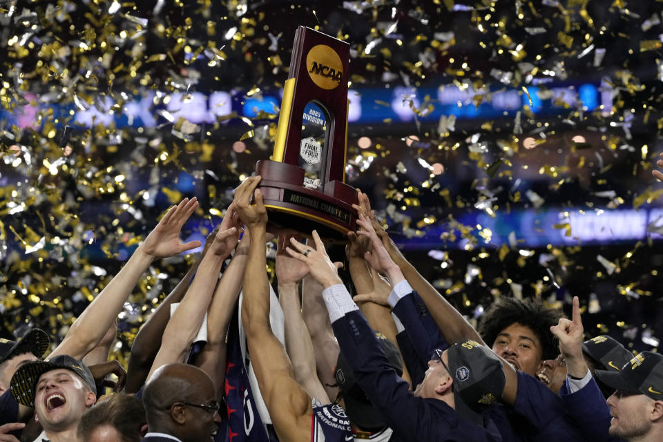 Connecticut celebrates with the trophy after their win against San Diego State during the men's national championship college basketball game in the NCAA Tournament on Monday, April 3, 2023, in Houston. (AP Photo/David J. Phillip)