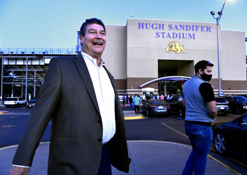 Hugh Sandifer, the retired Wylie High School head football coach, laughs as he walks with family and friends to the high school's stadium Friday, which had been renamed after him Nov. 6, 2020.