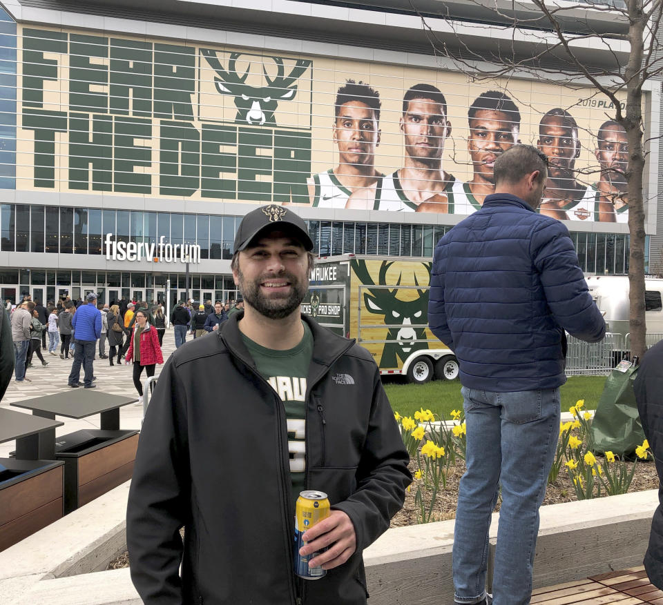 In this May 8, 2019 photo, Hunter Trimmel, 37, a Milwaukee resident who has been a Bucks fan since 1992, poses for a photo outside the Milwaukee Bucks' Fiserv Forum stadium before last Wednesday's game. (AP Photo/Ivan Moreno)