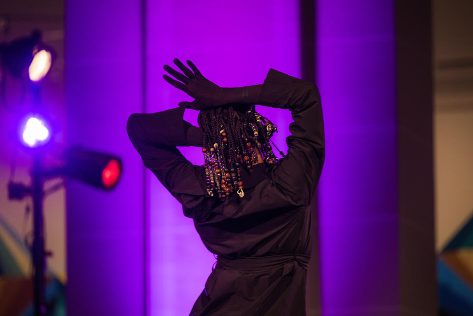 A person gestures during a musical performance (Bronson Farr for NBC News)