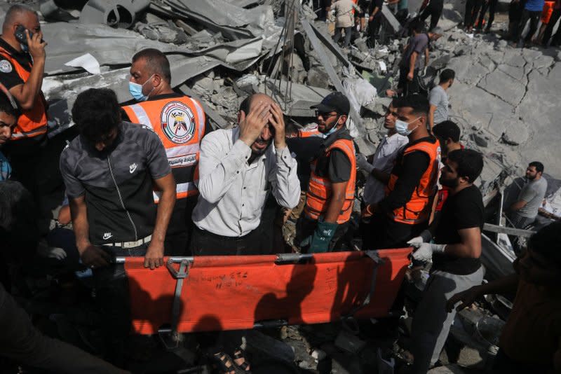 A Palestinian man reacts as the body of his daughter is unearthed from under the rubble after an Israeli strike on on Al-Ghouti family house in Rafah in southern Gaza on Sunday. Photo by Ismael Mohamad/UPI