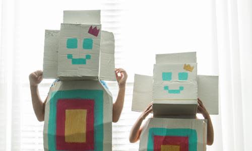 Young girls wearing homemade robot costumes at home