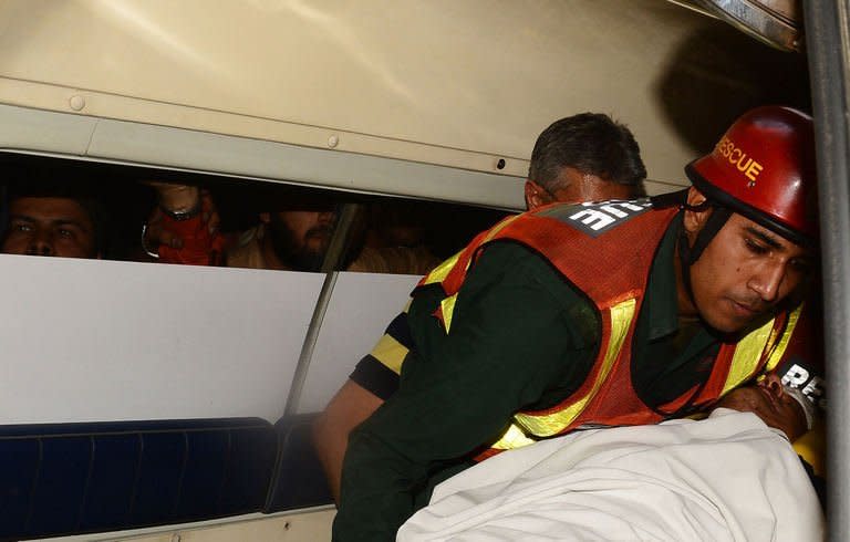 Pakistani politician and former cricketer Imran Khan is carried by rescuers to hospital in Lahore on May 7, 2013, after he fell off a lift taking him onto a stage at an election rally