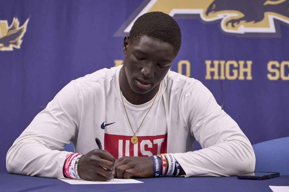 Apollo Hawks running back Adam Mohammed signs his commitment papers to the University of Arizona at Apollo High School in Glendale on Dec. 20, 2023.