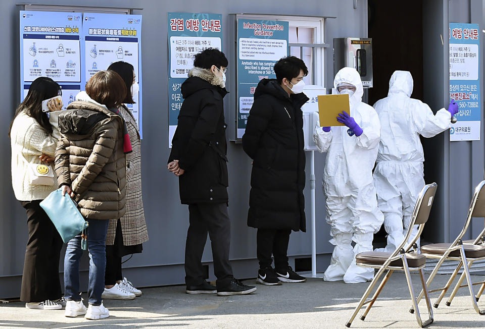 People suspected of being infected with the new coronavirus wait to receive tests at a medical center in Daegu, South Korea, Thursday, Feb. 20, 2020. The mayor of the South Korean city of Daegu urged its 2.5 million people on Thursday to refrain from going outside as cases of a new virus spiked and he pleaded for help from the central government. (Lee Moo-ryul/Newsis via AP)