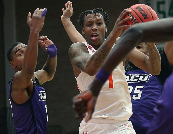 Texas-Rio Grande Valley&#39;s Justin Johnson (1) snags a rebound from Abilene Christian&#39;s Mahki Morris (12) and Immanuel Allen (25) during the Western Athletic Conference game Wednesday in Edinburg.