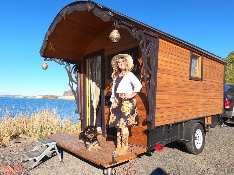 Stefanie Fisher standing with her tiny wagon home