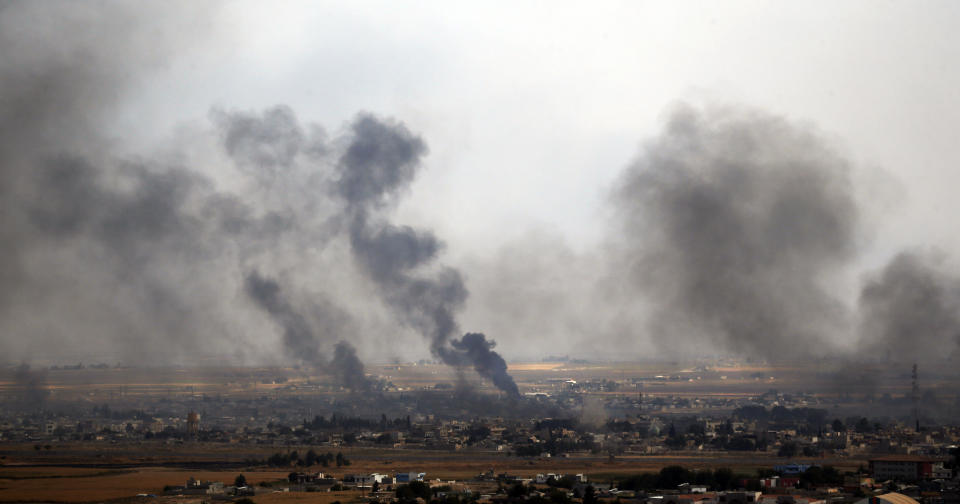 In this photo taken from the Turkish side of the border between Turkey and Syria, in Ceylanpinar, Sanliurfa province, southeastern Turkey, smoke billows from targets in Ras al-Ayn, Syria, during bombardment by Turkish forces, Wednesday, Oct. 16, 2019. Turkey's President Recep Tayyip Erdogan called Wednesday on Syrian Kurdish fighters to leave a designated border area in northeast Syria 'as of tonight' for Turkey to stop its military offensive, defying pressure on him to call a ceasefire and halt its incursion into Syria, now into its eighth day. (AP Photo/Lefteris Pitarakis)