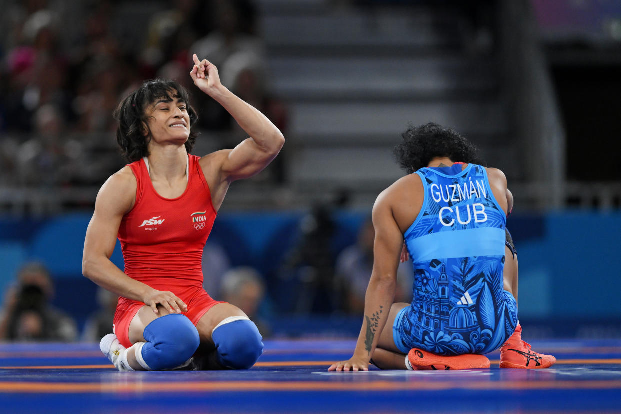 PARIS, FRANCE - AUGUST 06: Vinesh Vinesh of Team India (red) celebrates victory against Yusneylis Guzman Lopez of Team Cuba (blue) during the Wrestling Women's Freestyle 50kg Semifinal on day eleven of the Olympic Games Paris 2024 at Champs-de-Mars Arena on August 06, 2024 in Paris, France. (Photo by David Ramos/Getty Images)