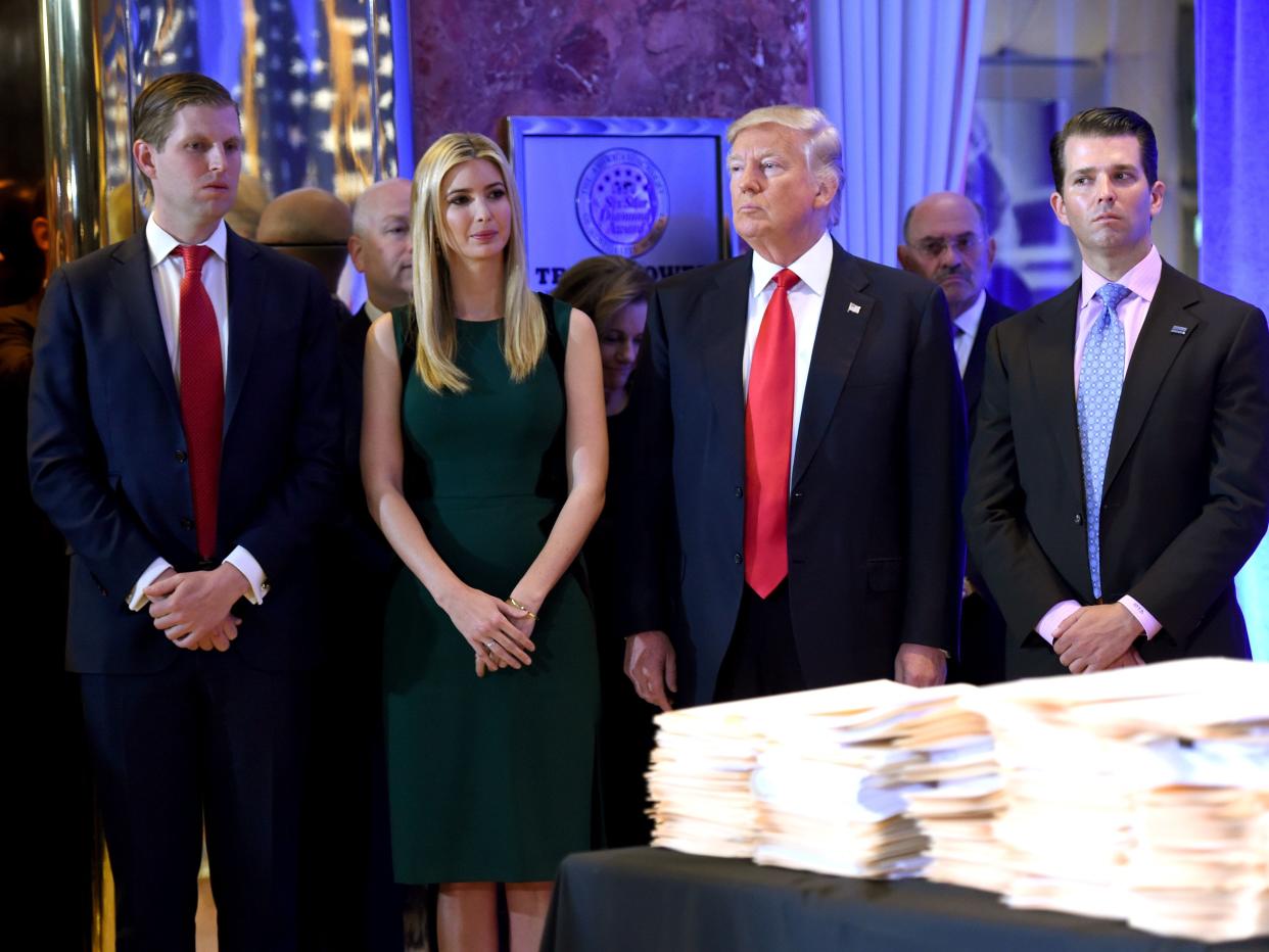 Donald Trump along with his children Eric(L) Ivanka and Donald Jr. arrive for a press conference January 11, 2017 at Trump Tower in New York.