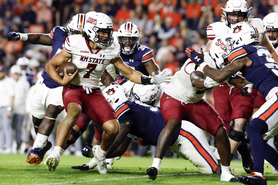 New Mexico State quarterback Eli Stowers (7) carries the ball against Auburn during the second half of an NCAA college football game Saturday, Nov. 18, 2023, in Auburn, Ala. (AP Photo/Butch Dill)