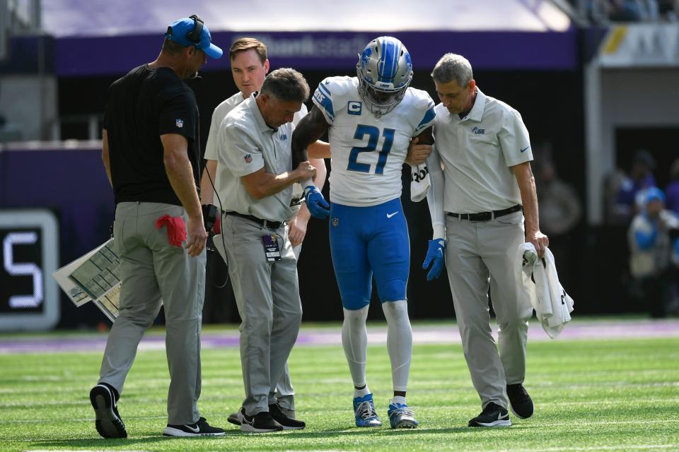 Lions safety Tracy Walker III (21) is helped off the field after getting injured during the first half of an NFL football game against the Vikings, Sunday, Sept. 25, 2022, in Minneapolis.