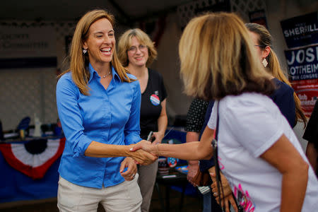FILE PHOTO: US Democratic congressional candidate Mikie Sherrill (L) campaigns as people attend the New Jersey State Fair in Augusta, New Jersey, U.S., August 12, 2018. REUTERS/Eduardo Munoz/File Photo