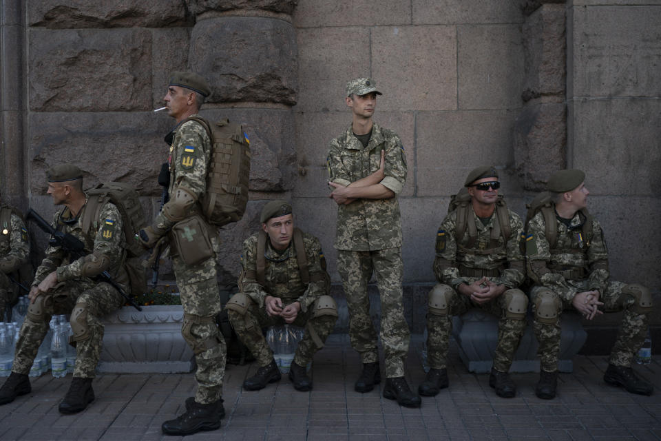 In this photo taken on Wednesday, Aug. 22, 2018 soldiers have a rest before a rehearsal for the Independence Day military parade in Kiev, Ukraine. Ukraine will mark the 27th anniversary of the Independence Day on Aug. 24. (AP Photo/Felipe Dana)