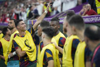 Portugal's Cristiano Ronaldo waves as he arrives to take his seat on the bench prior the start of the World Cup round of 16 soccer match between Portugal and Switzerland, at the Lusail Stadium in Lusail, Qatar, on Tuesday, Dec. 6, 2022. (AP Photo/Pavel Golovkin)