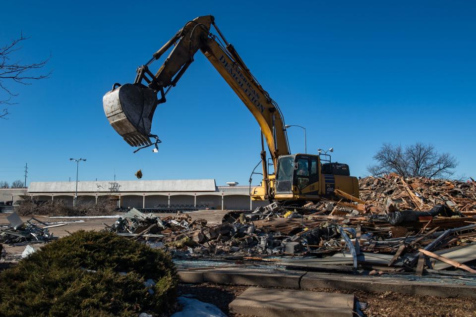 An excavator digs through rubble after the demolition of a former Radio Shack at 2505 S. College Ave. on Tuesday in Fort Collins.