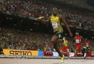 Usain Bolt of Jamaica crosses the finish line to win the men's 4 x 100 metres relay final during the 15th IAAF World Championships at the National Stadium in Beijing, China, August 29, 2015. REUTERS/Kai Pfaffenbach