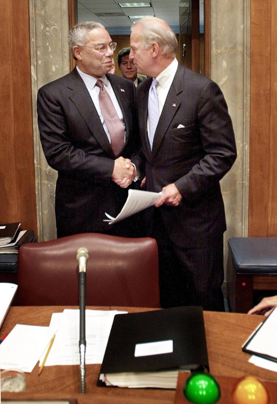 Secretary of State Colin Powell shakes hands with chairman of the U.S. Senate Foreign Relations Committee Joe Bidenon, Sept. 26, 2002, on Capitol Hill in Washington, D.C., prior to testifying on U.S. policy toward Iraq.