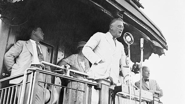 President Franklin D. Roosevelt at Fort Peck, Montana., on August 8, 1934 as he made one of his numerous addresses from the observation platform of his train during his journey over the parched plains of the Northwest. (AP Photo)
