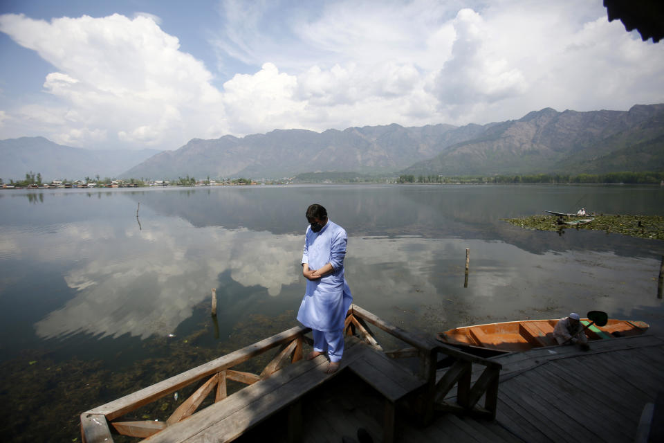 A Kashmiri Muslim man offers prayer on the banks of Dal Lake on the second day of Ramadan during lockdown to prevent the spread of the new coronavirus in Srinagar, Indian controlled Kashmir, Sunday, April 26, 2020. Kashmiri shrines that are usually packed with devotees during the holy month of Ramadan wore a deserted look Sunday as authorities closed the shrine for the safety of the public. (AP Photo/Mukhtar Khan)