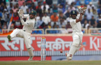 India's Wriddhiman Saha plays a shot as Australia's wicket keeper Matthew Wade (L) watches . REUTERS/Adnan Abidi