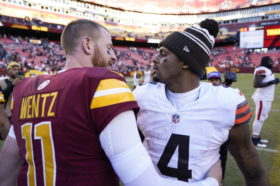 Cleveland Browns quarterback Deshaun Watson, right, hugs Washington Commanders quarterback Carson Wentz after a 24-10 victory, Sunday, Jan. 1, 2023, in Landover, Md. (AP Photo/Patrick Semansky)