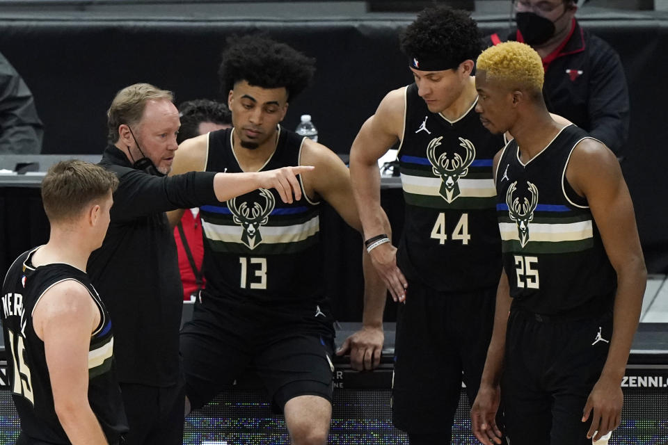 Milwaukee Bucks head coach Mike Budenholzer, second from left, talks to his team during the first half of an NBA basketball game against the Chicago Bulls in Chicago, Sunday, May 16, 2021. (AP Photo/Nam Y. Huh)