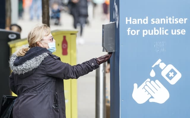 A woman uses a public hand sanitiser in Leeds 