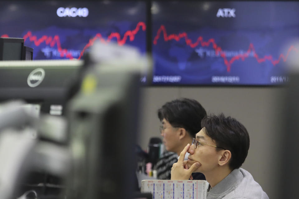 A currency trader watches monitors at the foreign exchange dealing room of the KEB Hana Bank headquarters in Seoul, South Korea, Monday, Dec. 9, 2019. Asian shares were mostly higher Monday cheered by a buying mood on Wall Street that came at the end of last week. (AP Photo/Ahn Young-joon)