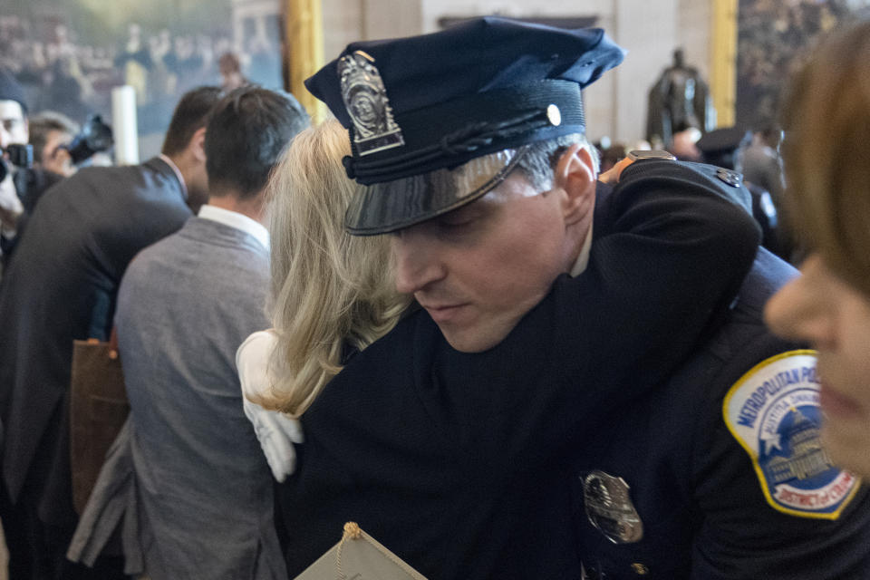 Rep. Liz Cheney, R-Wy., left, hugs D.C. Metropolitan Police Officer Daniel Hodges after a Congressional Gold Medal ceremony honoring law enforcement officers who defended the U.S. Capitol on Jan. 6, 2021, in the U.S. Capitol Rotunda in Washington, Tuesday, Dec. 6, 2022. (AP Photo/Alex Brandon)