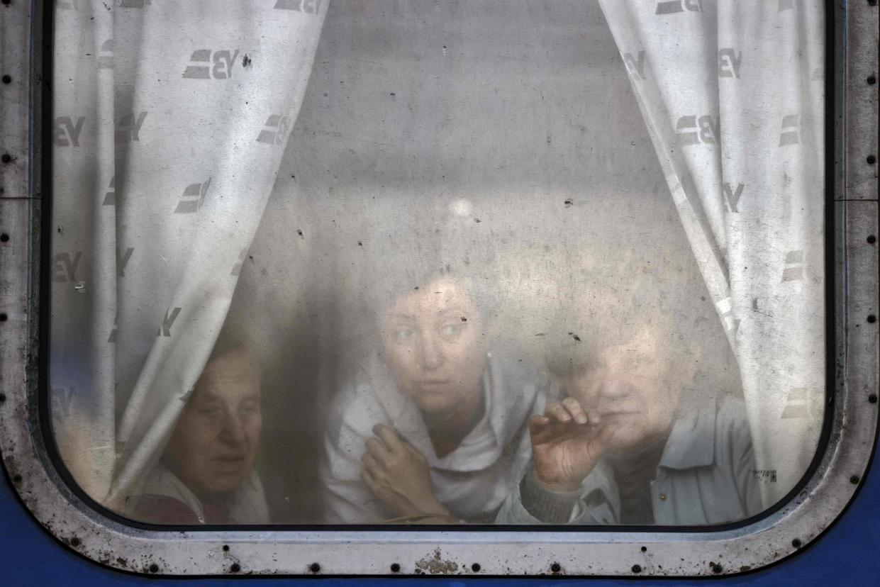 Women wave farewell to relatives as they are about to leave by train at Slovyansk central station, in the Donbass region on April 12, 2022, amid Russian invasion of Ukraine. The Ukrainian leaders of the Donetsk and Lugansk regions in the Donbas have asked civilians to evacuate west in reaction to an anticipated Russian offensive to take the eastern region. (Photo by RONALDO SCHEMIDT / AFP) (Photo by RONALDO SCHEMIDT/AFP via Getty Images) ** OUTS - ELSENT, FPG, CM - OUTS * NM, PH, VA if sourced by CT, LA or MoD **