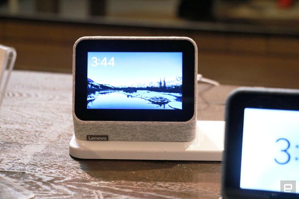 <p>A gray Lenovo Smart Clock 2 on a wireless charging dock with its screen facing the camera.</p>
