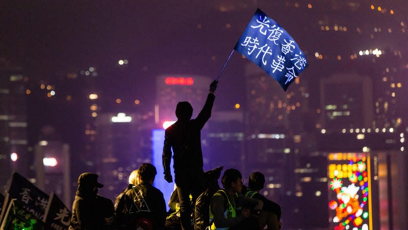 Hong Kong protester waves a “Liberate Hong Kong” flag in 2019.