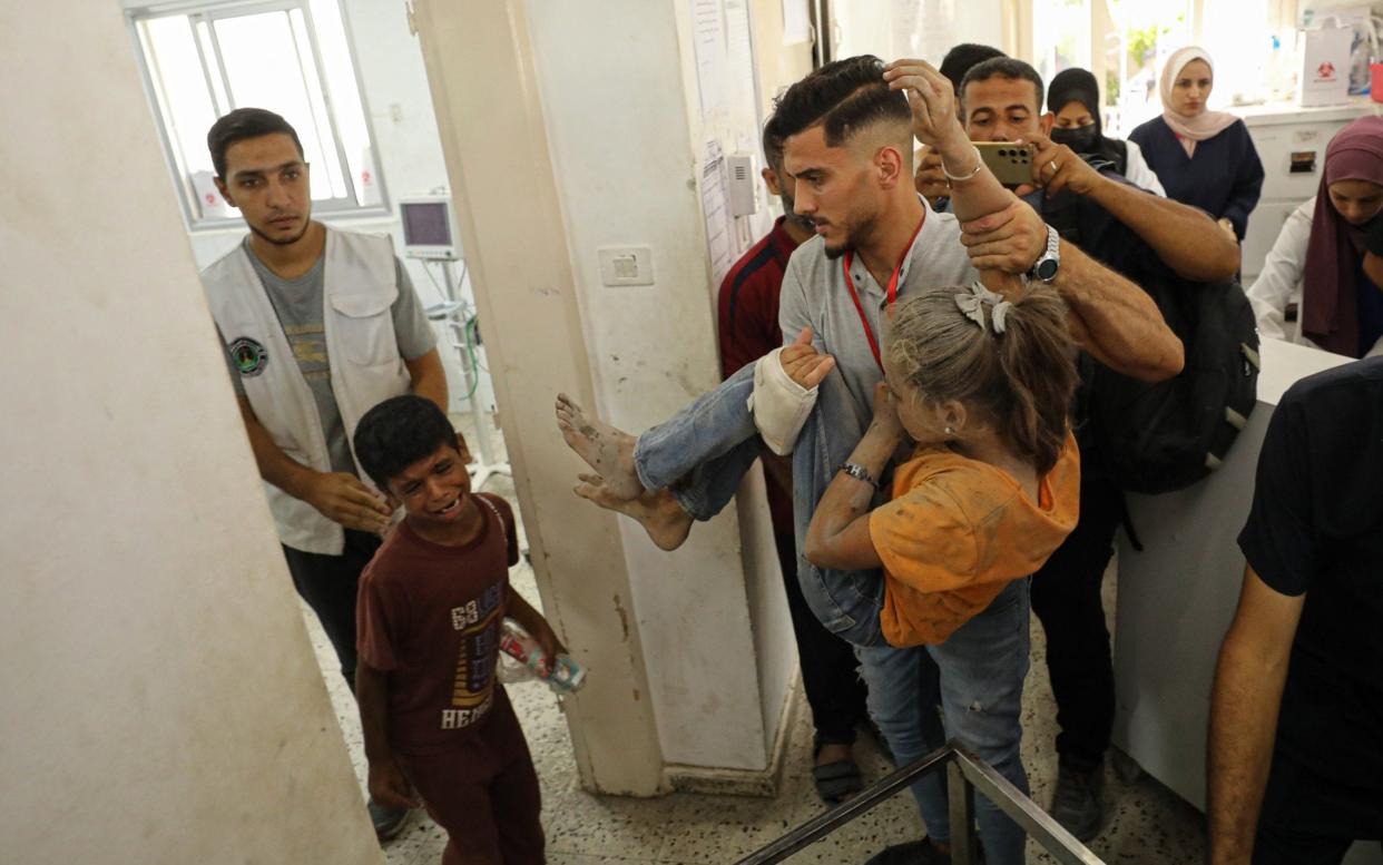 Palestinians, including children, injured in an Israeli strike on Ibn al-Haitham school in Gaza City are brought to hospital