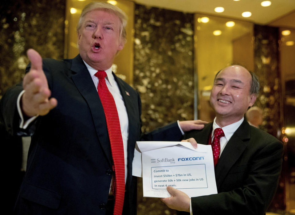 President-elect Donald Trump, left, accompanied by SoftBank CEO Masayoshi Son, speaks to members of the media at Trump Tower in New York. (AP Photo/Andrew Harnik, File)