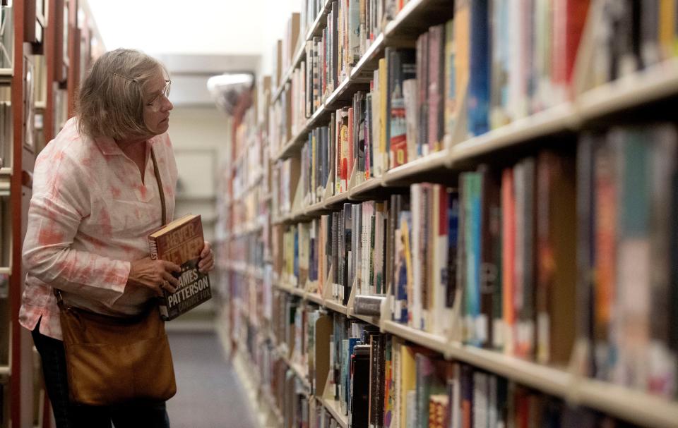 Margie Rawls looks for a book Wednesday, Sept. 29, 2021, at Indianapolis Public Library's Glendale Branch. The site currently sits in a shopping center next to a Staples. Construction on its new location has been delayed due to a labor shortage and an increase in the cost of materials due to the pandemic. 