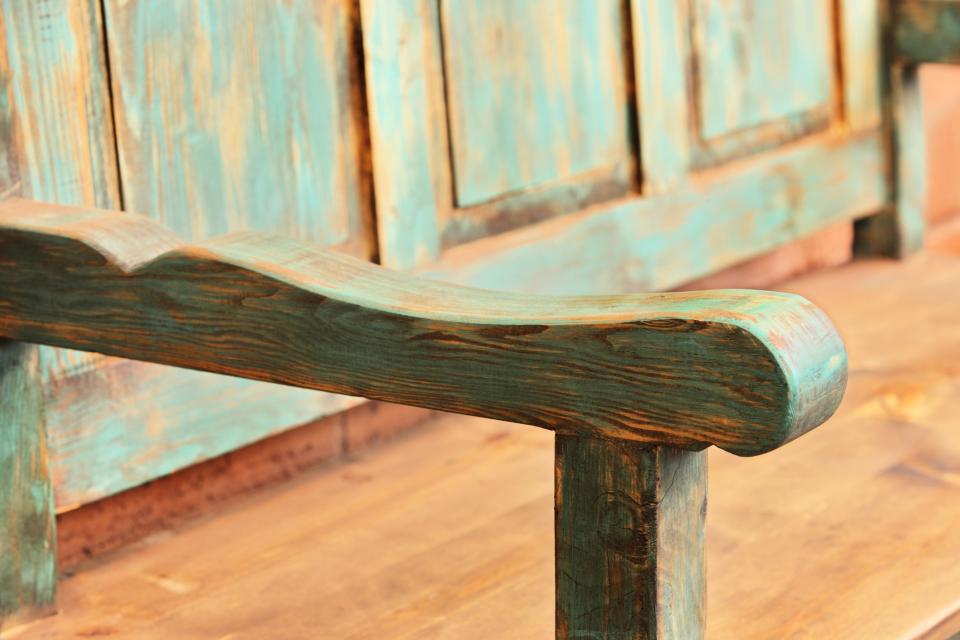 Wooden bench furniture produced by modern methods but finished to appear as if Mexican artisans from a past era produced it by hand. Sedona, Arizona, 2013.