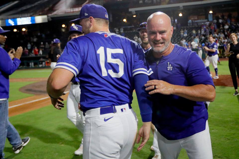 OKC Dodgers manager Travis Barbary celebrates with infielder Michael Busch, who hit a three-run home run Wednesday night.