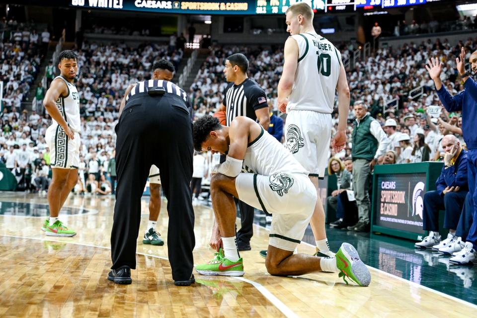 Michigan State's Malik Hall reacts after falling into the Michigan bench during the first half on Saturday, Jan. 7, 2023, at the Breslin Center in East Lansing.