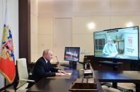 Russian President Vladimir Putin speaks to Ella Pamfilova, head of Russian Central Election Commission, on the screen, during their meeting via video conference at the Novo-Ogaryovo residence outside Moscow, Russia, Monday, Sept. 20, 2021. (Alexei Druzhinin, Sputnik, Kremlin Pool Photo via AP)