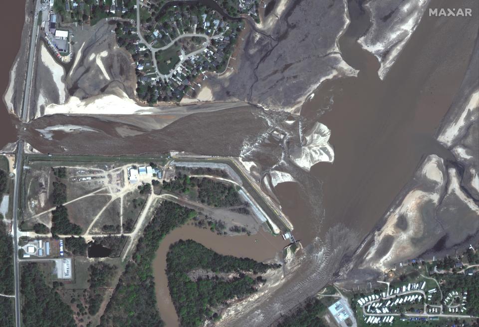 This photo provided by Maxar Technologies shows Edenville Dam in Beaverton, Mich., Thursday, May 21, 2020, after it was damaged. (Maxar Technologies via AP)