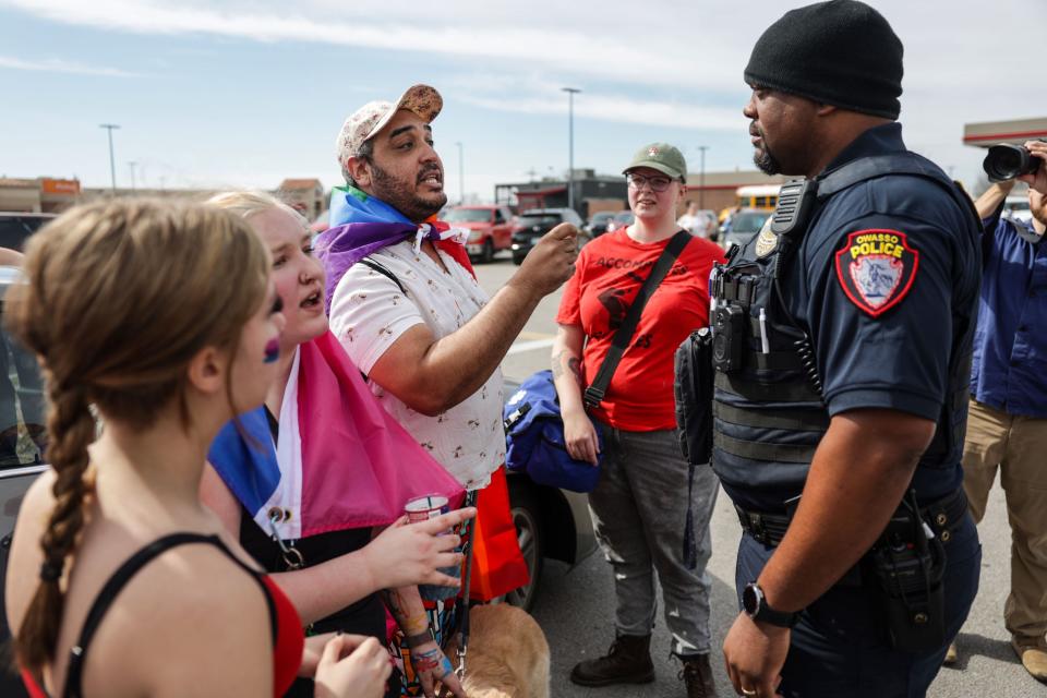 Owasso Police Officer Malone works to de-escalate a tense situation on Feb. 26 when an anti-lgbtq protester (not shown) was confronted during a planned student walkout at Owasso High School in response to the death of Nex Benedict in Owasso. The walkout was not sanctioned by the school. Activists and groups from outside school participated as well.