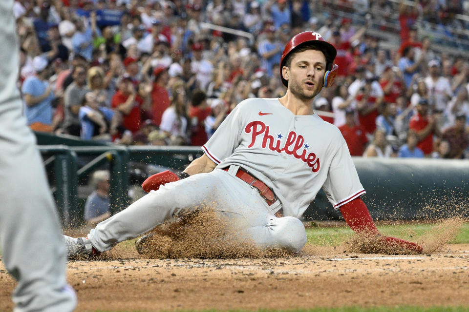 Philadelphia Phillies' Trea Turner slides home to score on a double by J.T. Realmuto during the fourth inning of a baseball game against the Washington Nationals, Friday, Aug. 18, 2023, in Washington. (AP Photo/Nick Wass)