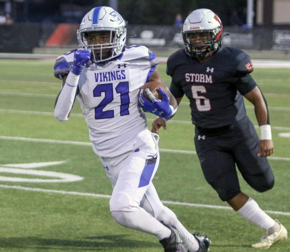 Lakeland Christian running back Jacob Allen runs up field while Victory Christian's Martell Thomas gives chase.